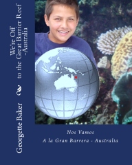 A boy is holding a globe in front of some plants.